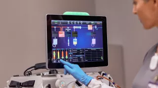 Healthcare professional interacts with the PrisMax system monitor