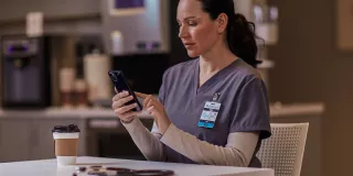 Healthcare professional sitting at table on phone