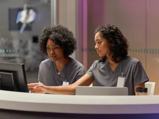 Two healthcare professionals looking at computer