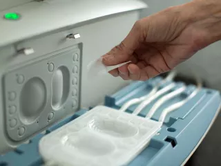 We see a hand interacting with the Amia system