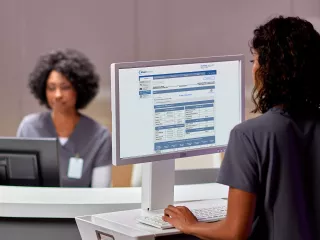 Woman on laptop viewing Sharesource remote patient management